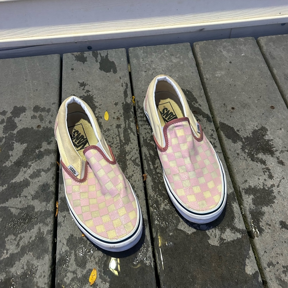 Worn pink and crème checkered vans.